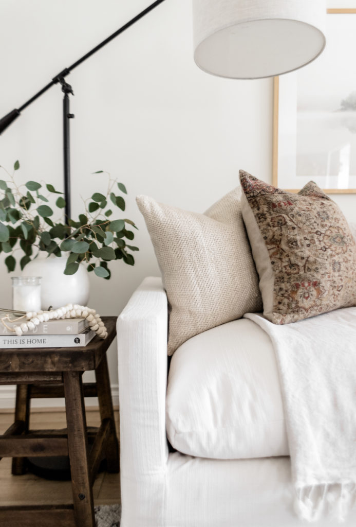 Living Room Update: World Market Sofa Reveal - Halfway Wholeistic; Click to see this living room update on Halfway Wholeistic! Our ivory sofa from World Market arrived & it's as pretty in person as online! The color is creamy white. The polyester-nylon upholstery is great! Living room decor ideas modern luxury. Living room ideas cozy warm rustic. Living room furniture arrangement ideas with fireplace and tv. Living room ideas modern contemporary luxury. Living room furniture sets couch. Couch pillow arrangement color combos. 